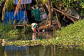 Kerala backwaters, our three hours neighborhood tour in the narrow canoe towards Vembanad Lake and along one of the  narrow canal running near our guest house at Kumarakom. 